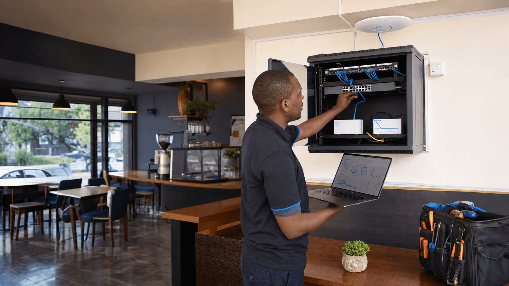 Network technician configuring business WiFi equipment